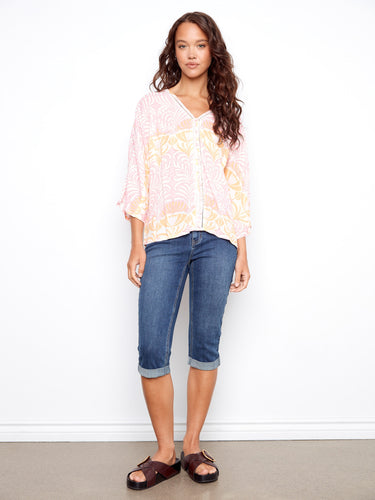Versatile top featuring ladder stitch details that offer a subtle yet eye-catching element to this lovely garment. Ideal all year round! by Charlie B.