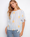 Striped dolman top with a boat neckline and sunny embroidery, featuring a side tie by Charlie B.