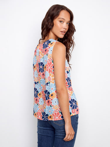 Colorful floral blouse showcasing a sleeveless design, offering comfort and style in warm weather. By Charlie B.