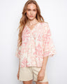 Blouse with wide elbow sleeves and a relaxed fit, featuring an abstract pink and white pattern with v-neck by Charlie B.