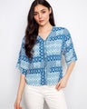 Blue patterned top with a V-neckline, showcasing wide elbow sleeves for a stylish look by Charlie B.