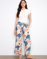 Floral pants with a self belt tie, offering a chic and adjustable fit. Perfect for any occasion. By Charlie B.