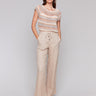 Biscuit-colored pants with a utility pocket design by Charlie B.