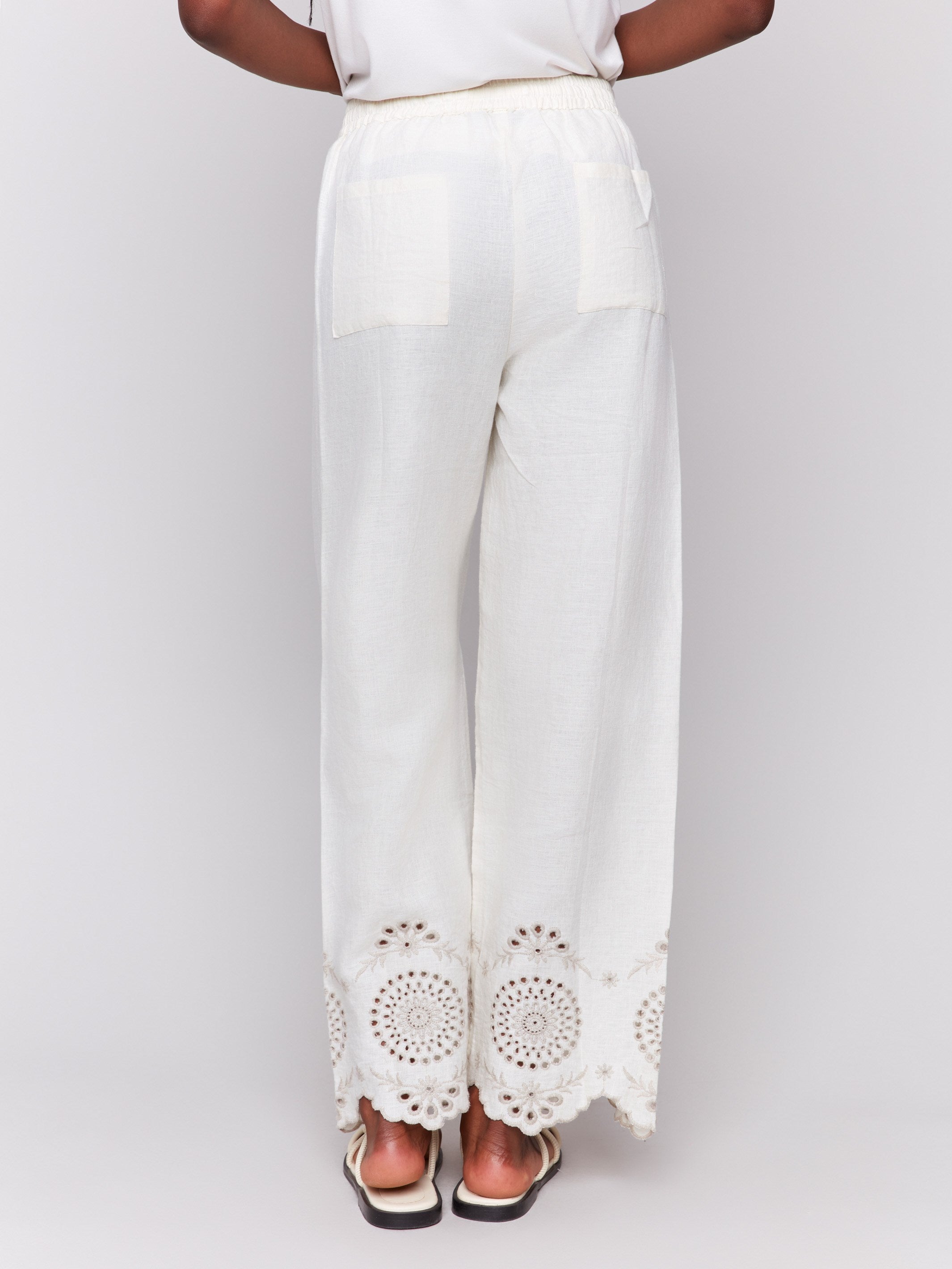 Long length linen pants featuring elegant eyelet embroidery detail by Charlie B.