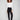 Black slim-leg pants featuring a skinny fit and styled with a white top, highlighting the sleek design by Charlie B.