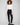 Black slim-leg pants featuring a skinny fit and styled with a white top, highlighting the sleek design by Charlie B.