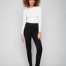 Black slim-leg pants featuring a skinny fit and styled with a white top, highlighting the sleek design by Charlie B.