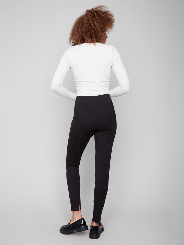 Sophisticated black pants with slit detail at the hem, complemented by a white top for modern flair by Charlie B.