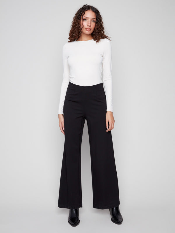 Black pants featuring a wide leg design for a chic silhouette, ideal for versatile styling by Charlie B.