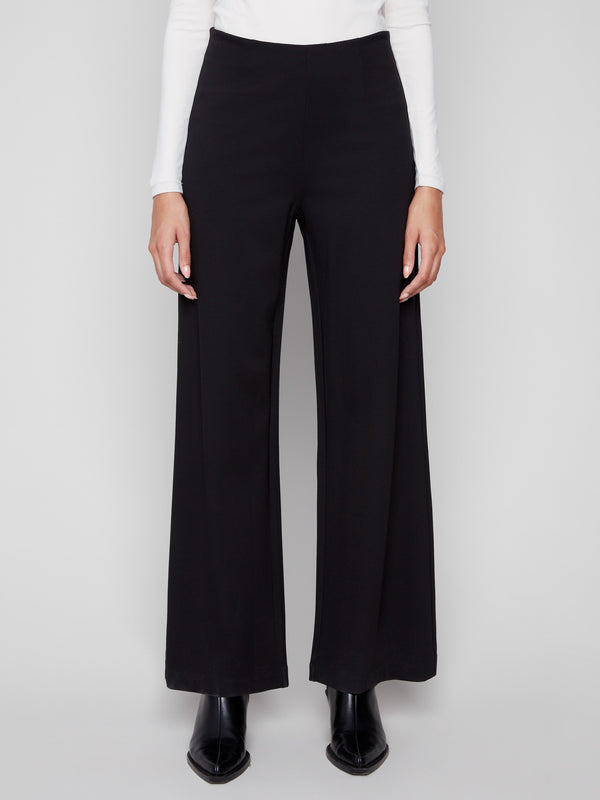 These long black pants offer an elegant look with their extended length and sleek finish by Charlie B.