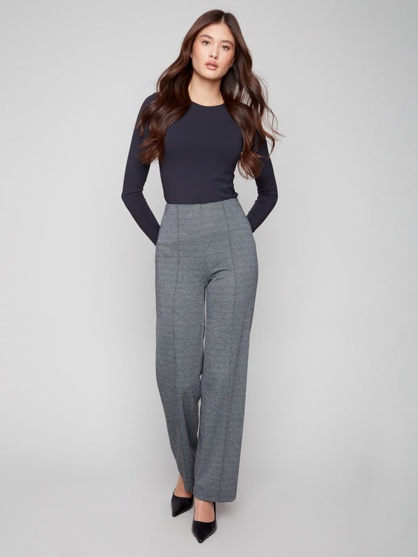 Black pull-on pants with a wide leg and elegant front dart detailing by Charlie B.