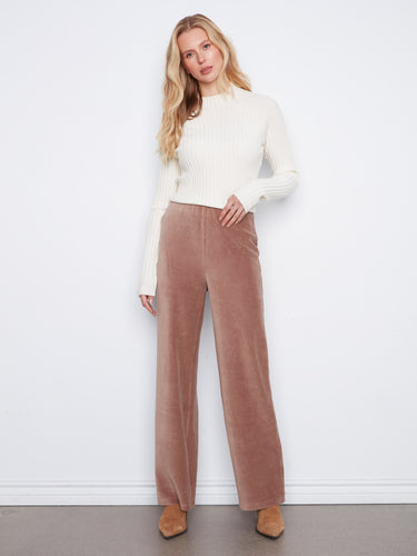 Taupe wide-leg corduroy pants in a full-length cut, paired with a white ribbed sweater by Charlie B.
