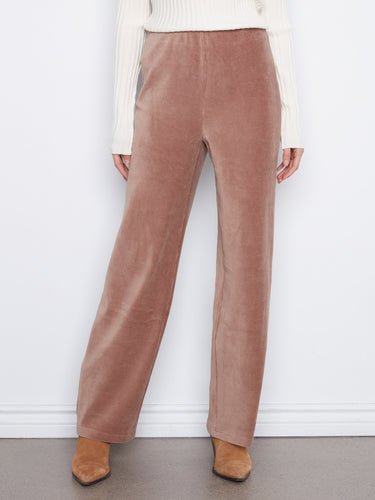 Taupe corduroy pants with stretch fabric, styled elegantly with a white ribbed sweater by Charlie B.