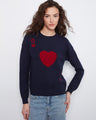 Navy sweater with a striking jacquard design featuring red heart motifs, paired with casual jeans for a relaxed look by Charlie B.
