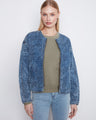 The denim jacket's welt pockets offer practical storage without compromising on its sleek design aesthetic by Charlie B.