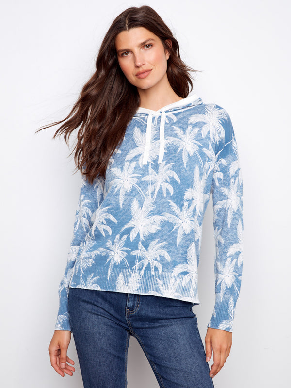 Blue palm tree hoodie featuring a unique reverse print design, perfect for casual outings. Made with soft fabric for comfort by Charlie B.
