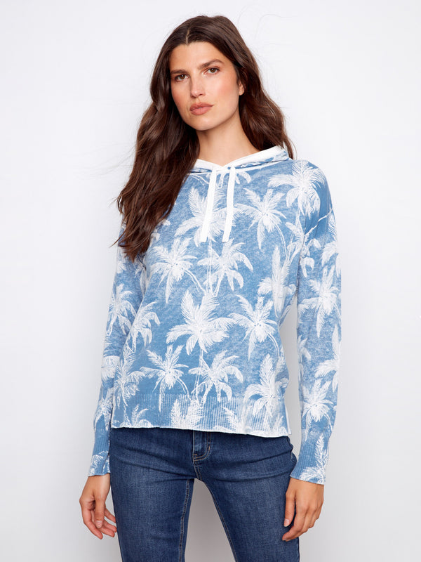 Comfortable and chic palm tree printed hoodie in blue, offering a relaxed fit and cozy style. Perfect addition to your wardrobe by Charlie B.