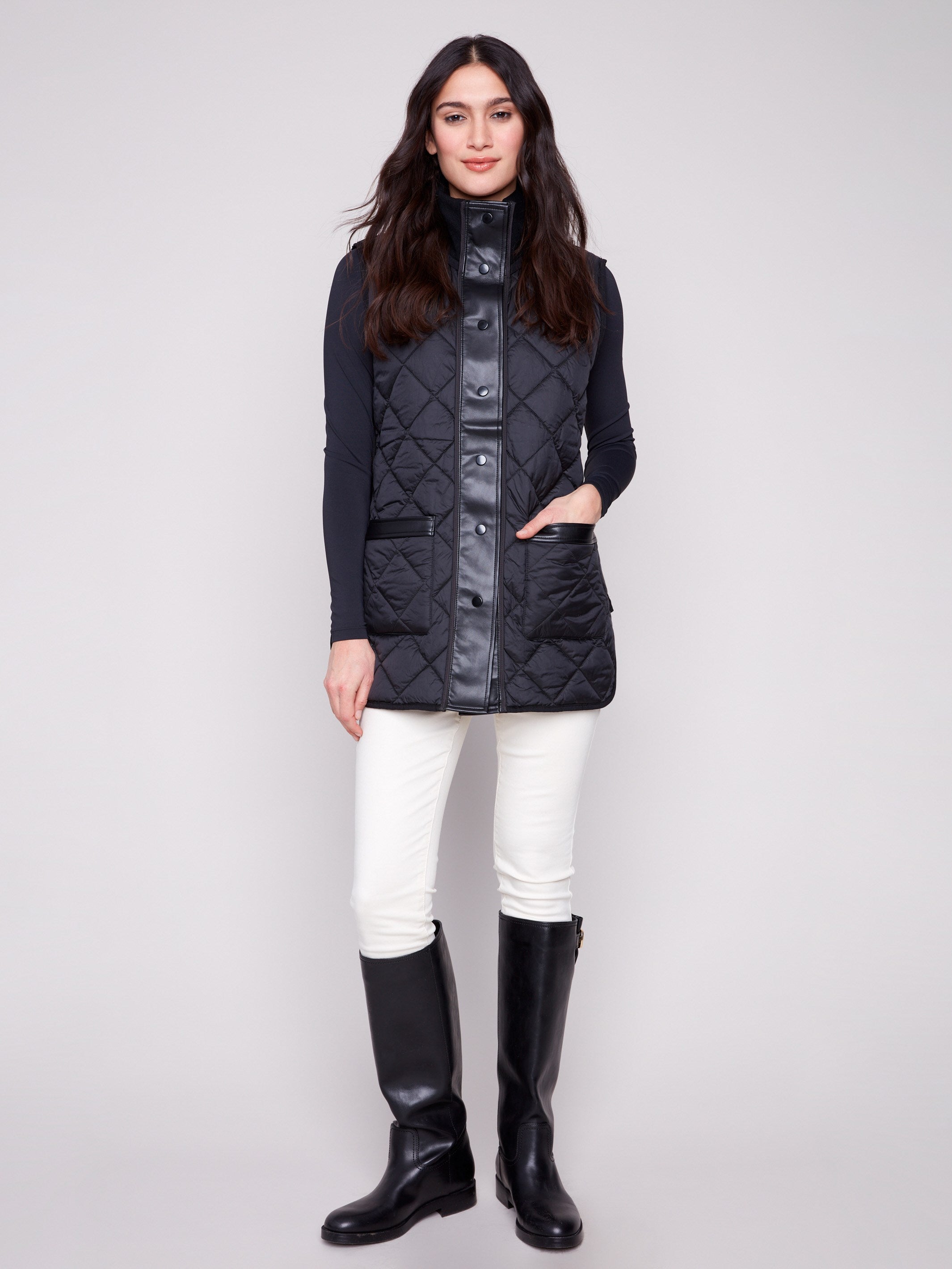 Black quilted vest emphasizing the reversible feature and stylish front patch pockets by Charlie B.