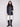 Black quilted vest emphasizing the reversible feature and stylish front patch pockets by Charlie B.
