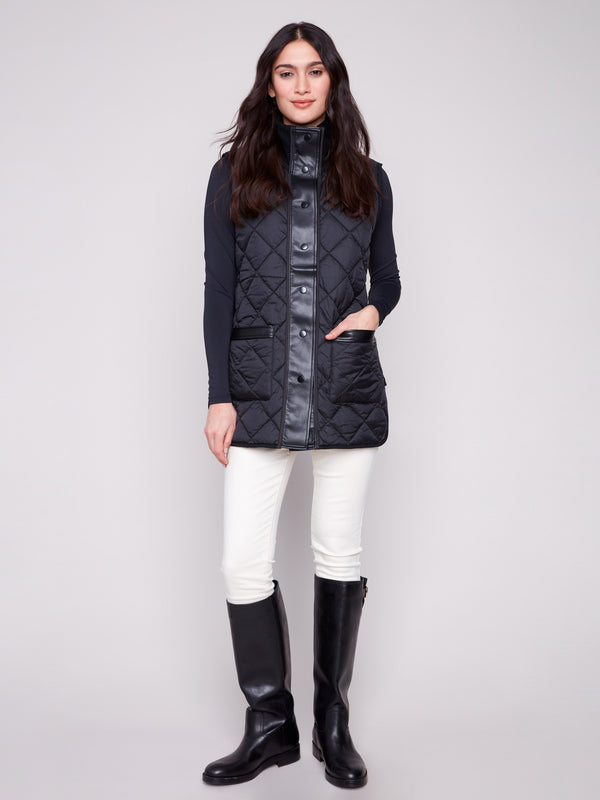 Black quilted vest emphasizing the reversible feature and stylish front patch pockets by Charlie B.