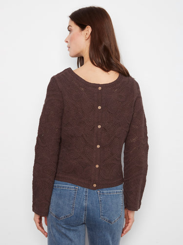 The intricate knit pattern enhances the aesthetic appeal of this classic long-sleeve sweater. Created by Charlie B.