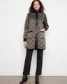 Green quilted puffer jacket featuring a reversible design and stylish patch pockets by Charlie B.
