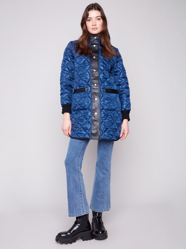 Navy quilted jacket with rib knit detailing and faux leather accents, adding a stylish touch to your wardrobe by Charlie B.