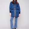 Navy quilted jacket with rib knit detailing and faux leather accents, adding a stylish touch to your wardrobe by Charlie B.
