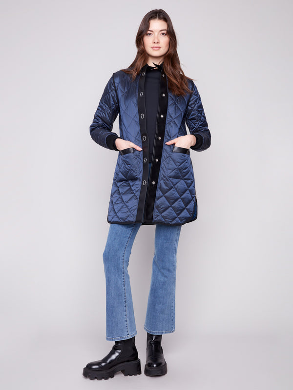 Reversible navy puffer jacket featuring snap buttons and cozy rib-knit cuffs for a versatile look by Charlie B.
