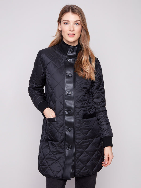 Stylish reversible quilted design in a black puffer jacket with side zipper details by Charlie B.