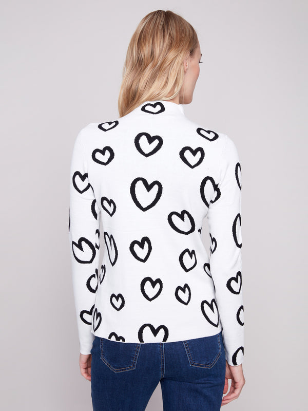Versatile reversible sweater showcasing a playful heart pattern with long sleeves for comfort by Charlie B.