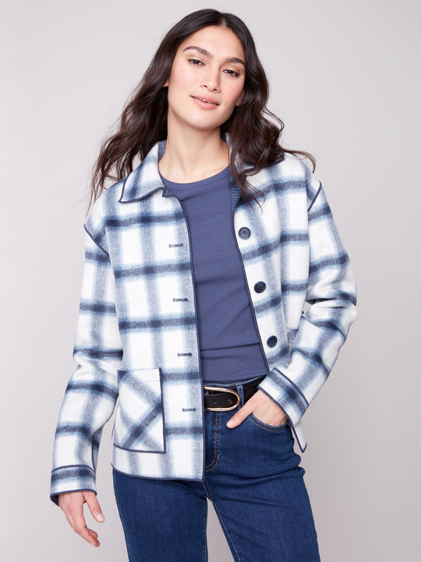 Functional patch pockets add practicality to this fashionable plaid jacket by Charlie B.