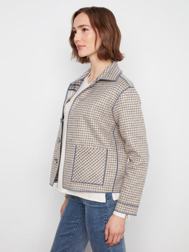 The reversible design of this checkered jacket offers two looks in one, enhancing its utility. By Charlie B.