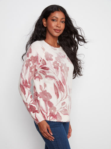 Charming floral sweater with long raglan sleeves offers both warmth and elegance, great for cooler days by Charlie B.