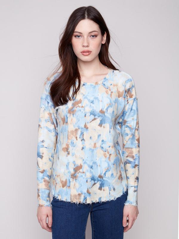 Abstract printed sweater in vapor tones with a reversible design and frayed edges, ideal for versatile styling by Charlie B.