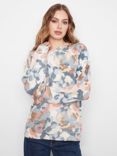 Sweater with a classic crew neck, featuring a playful floral pattern in pastel hues for a stylish touch. By Charlie B.