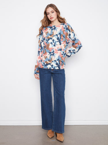 A chic long-sleeve sweater in soft colors, perfect for layering during cooler days while staying fashionable. By Charlie B.