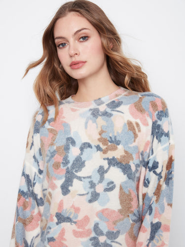Embrace comfort with this crew neck sweater crafted from soft fabric and adorned with an eye-catching floral design. By Charlie B.