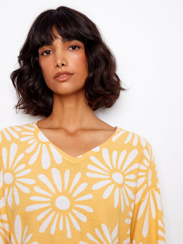 Long sleeves provide warmth and comfort in this charming floral sweater, ideal for cooler days. Experience quality craftsmanship by Charlie B.