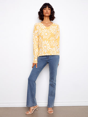 Yellow floral-patterned garment made from pure cotton, designed to elevate your wardrobe effortlessly. By Charlie B.