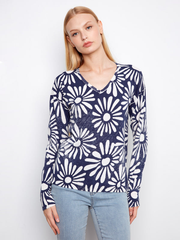 Navy blue and white sweater with a floral pattern, featuring a v-neckline. Made from 100% cotton for comfort by Charlie B.