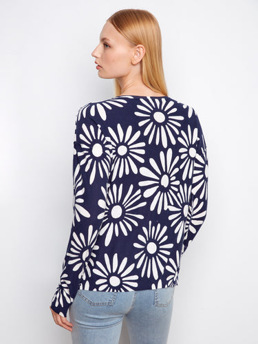 White and navy floral print sweater with elegant long sleeves. A chic addition to any wardrobe by Charlie B.