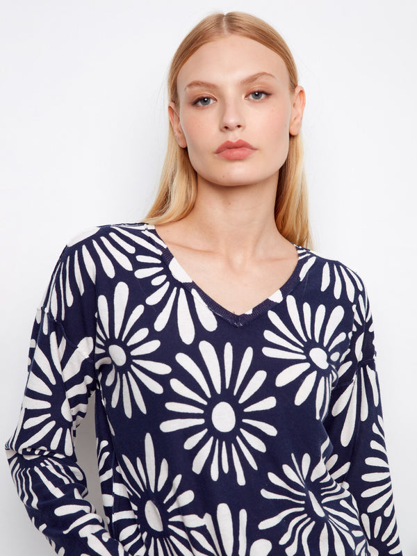 Navy blue reversible sweater featuring a vibrant floral pattern. Designed for both fashion and function by Charlie B.