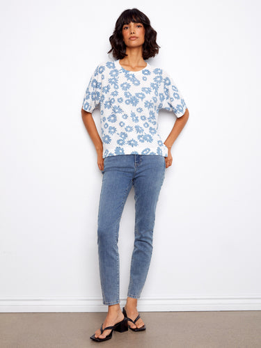 Featuring short sleeves and a charming floral pattern, this top is both stylish and comfortable for everyday wear. By Charlie B.