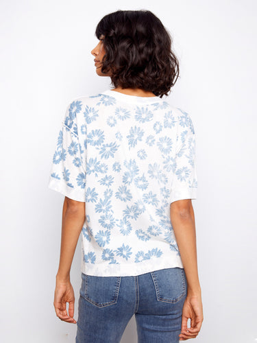 A versatile addition to your closet with its classic crew neckline and elegant floral motif—ideal for any occasion. By Charlie B.