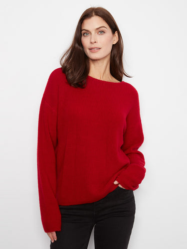 This red sweater features a reversible design, providing two stylish looks in one garment. By Charlie B.