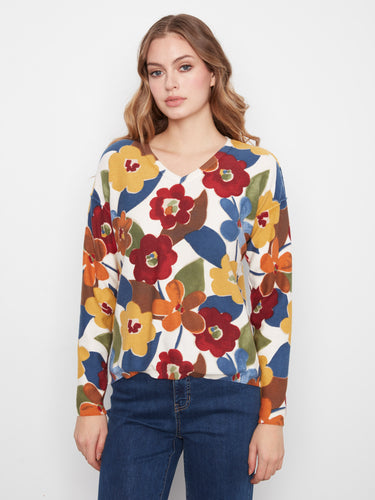 This reversible print sweater showcases vibrant florals, offering two looks in one. A must-have versatile piece by Charlie B.