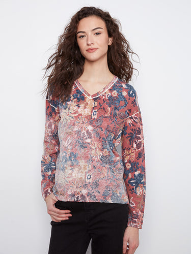 Elegant floral top with drop shoulders, offering a relaxed fit. Made from a cozy cotton blend for ultimate comfort by Charlie B.