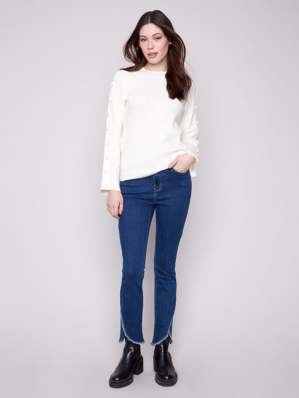 Ribbed knit ecru sweater with stylish button details on the sleeves by Charlie B.