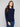 Navy sweater featuring ribbed knit texture with stylish button accents on the sleeves, adding a unique touch. By Charlie B.